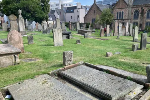 A view across gravestones and other grave markers at Old High Church in Inverness.