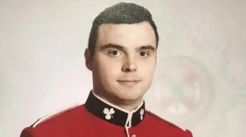 L/Cpl Bernard Mongan wearing red army uniform, with short brown hair