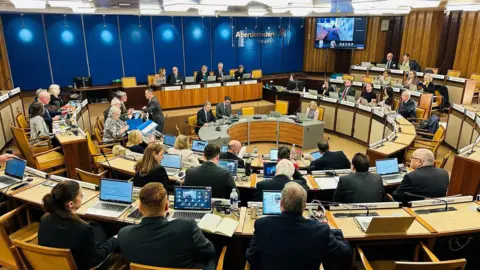 Councillors in a meeting room of Aberdeenshire Council.