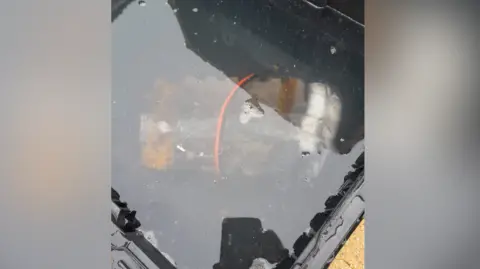 West Sussex Fire and Rescue Service A lithium-ion battery from an e-bike conversion kit in a bucket of water.