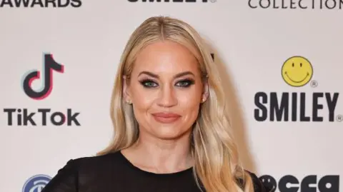 Getty Images A woman with blonde hair smiles at the camera.