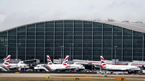 Planes lines up at Heathrow Airport