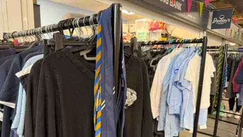 Multiple rails of school uniform.