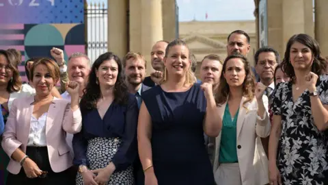 BERTRAND GUAY/AFP French newly-elected Members of Parliament (MPs) for La France Insoumise political party (LFI) of the leftist coalition "Nouveau Front Populaire" (New Popular Front - NFP) pose for a photo group session as they arrive to the National Assembly in Paris, on July 9, 2024