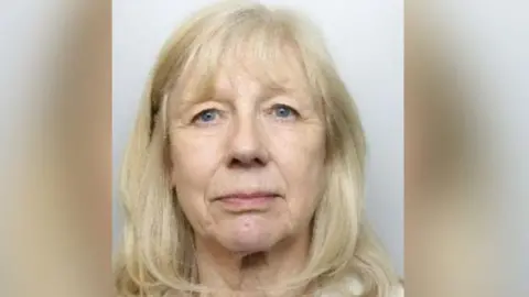 Pamela Teasdale, with blonde hair and a fringe, blue eyes. Pictured in her mug shot