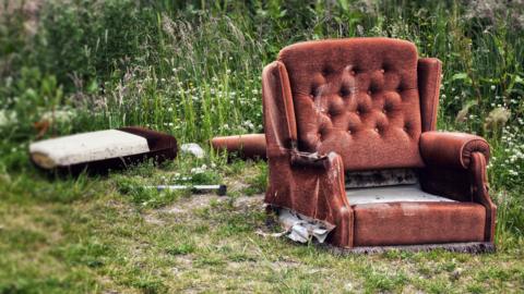Abandoned armchair in a field