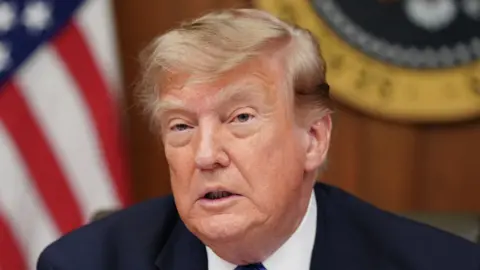 US President Donald Trump speaks during a Cabinet meeting at Camp David.