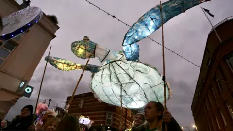 Plaster Communications A large turtle lantern being carried by festival goers during the annual Bedminster Winter Lantern Parade