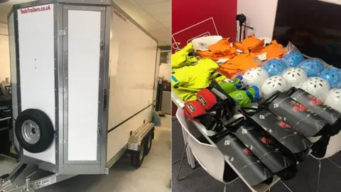 A white trailer in a compound (left) and a table with various kit including helmets and clothing for sea cadet training on the water on a white table  