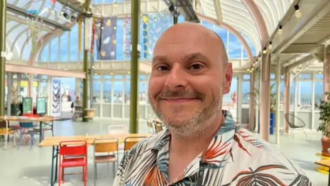 Andrew Turner/BBC Lee Johnson, chair of Beccles Lido Ltd, standing inside East Point Pavilion in Lowestoft.