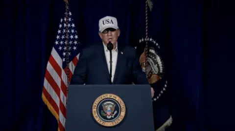 Image of Trump at the podium delivering his speech