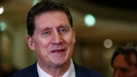 PA Media Eamon Ryan smiling and looking slightly off camera 