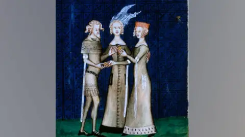 Getty Images An illustration of a knight and a lady exchanging rings, c1350, from a courtly love poem by Guillaume de Machaut, the knight accepting a ring from the woman, with a second woman watching in the middle.