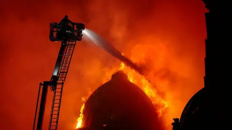 Getty Images A domed building on fire, with flames covering it
