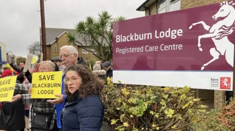 John Nurden People gather outside Blackburn Lodge