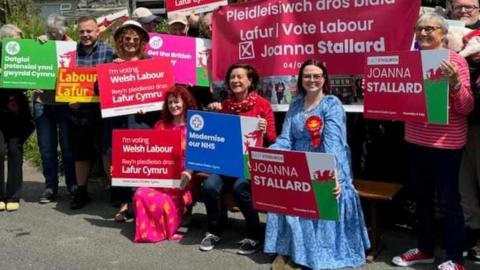 Group of Labour activists in north Wales, with Eluned Morgan holding a sign saying "Modernise Our NHS"