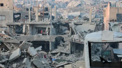 Getty Images A view of the destruction in Beit Lahia, Northern Gaza, as residents gather for iftar on 15 March.