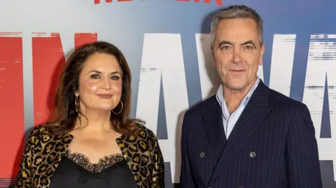 Getty Images Ruth Jones and James Nesbitt at the Run Away premiere. Ruth wears a black cami top with lace detailing and a leopard print jacket. James wears a light blue shirt and a pinstripe, button-up navy suit jacket