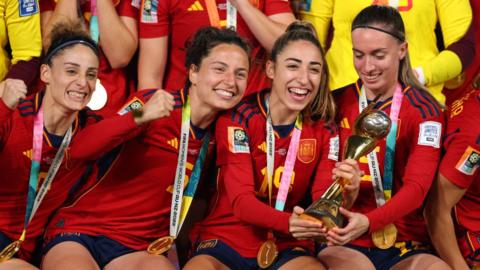 Ivana Andres, Olga Carmona and Eva Navarro of Spain celebrate with the trophy during the FIFA Women's World Cup