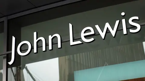 White lettering saying "John Lewis" on a glass shop frontage