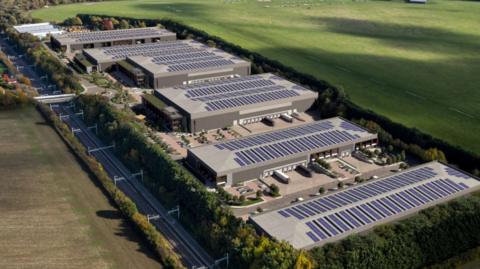 How the revamped office park would have looked, with six large units with lorries outside three of them and solar panels on top of them, with train lines running to the left of them and the airfield to the right of the park
