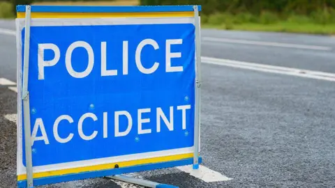Getty Images A police accident sign on a road, with 'police accident' in bold white letters on a blue background.