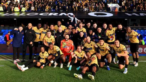 Getty Images Maidstone United's squad celebrate their win over Ipswich