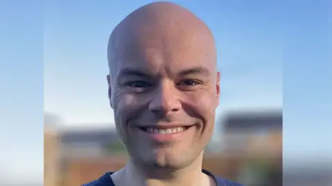 An image of Ben Nutland smiling at the camera