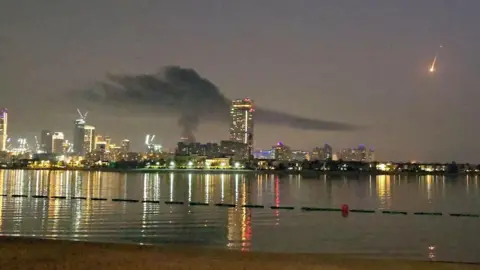 Reuters Smoke rises over a hotel damaged in Dubai's famed Palm Jumeirah, in Dubai, United Arab Emirates, February 28, 2026 in this screen capture from video.