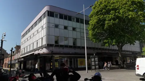 BBC News Lincoln's House of Fraser, a large, white, box-like building, was given a plain modern facade in the 1960's. There has been a department store on this site since the early 1900's. The shop is due to close in May 2025.