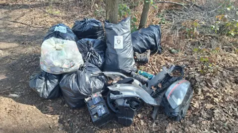 WLW The image shows bin bags on the floor with random broken items in them.