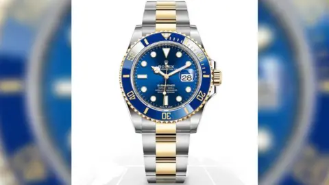 Rolex A Rolex watch with a blue face and a chrome and gold strap