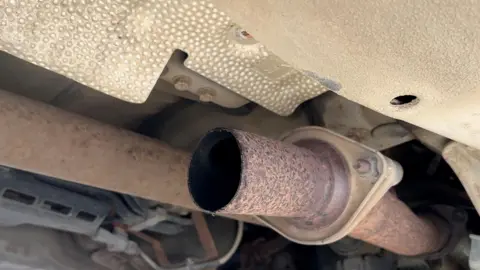 A pipe underneath Richard's car which has been sawn off.