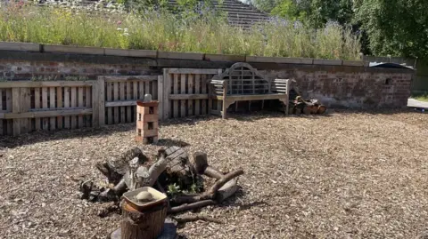 Brookfield Allotment Wooden pallets and a bench line the bunker, with logs and drinking stations placed for birds and insects placed in front.