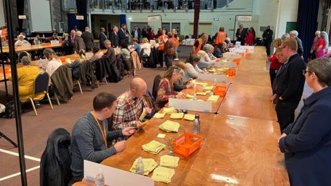 People counting votes in the hall