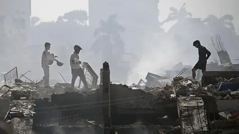 Volunteers search for possible victims in a collapsed building following twin earthquakes in Venezuela.