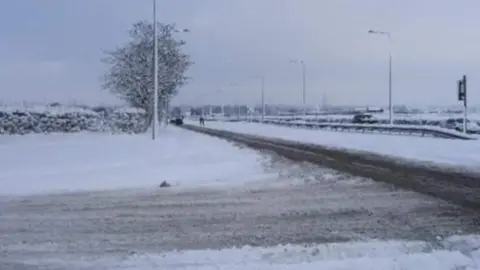 Keith Jones The A59 with one lane of traffic with thick on either side of the road