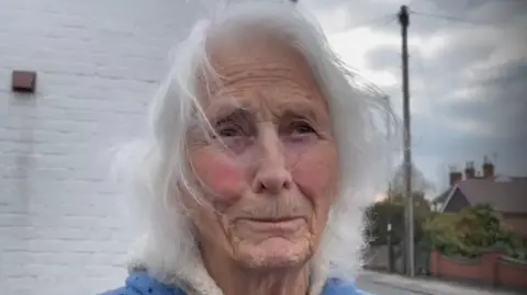 An older woman with long white hair