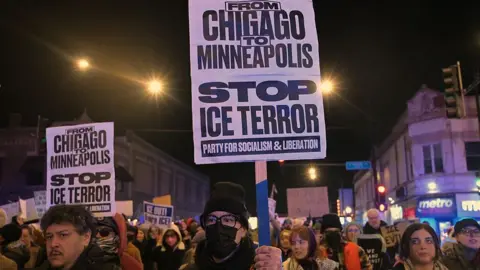Anadolu via Getty Images Various protesters are holding signs at this organised protest in Chicago. One reads "From Chicago to Minneapolis stop ice terror".