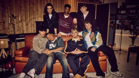 Frank Fieber Seven teenage members of the band December 10 sat on a sofa looking to camera 