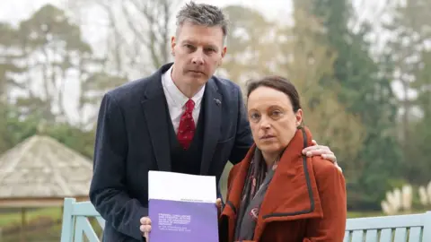 PA Media Rhiannon Davies and Richard Stanton with a copy of the Donna Ockenden Independent Review into Maternity Services at the Shrewsbury and Telford Hospital NHS Trust