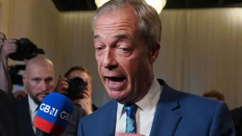 Nigel Farage speaking into a GB News microphone