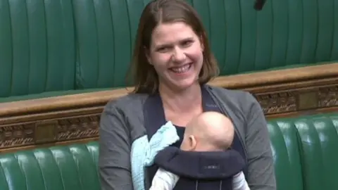 PA Jo Swinson and baby Gabriel in the UK House of Commons