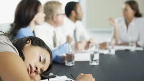 Getty Images Businesswoman asleep in meeting