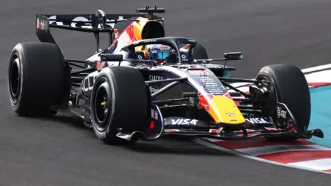 Red Bull's Max Verstappen drives across a kerb during the 2026 Japanese Grand Prix