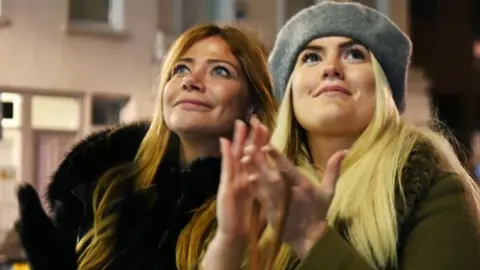 EPA Young women clap for heroes in London on 7 January 2020