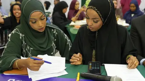 Shukri Mohamed Abdi Two judges of the competition are looking at a piece of paper