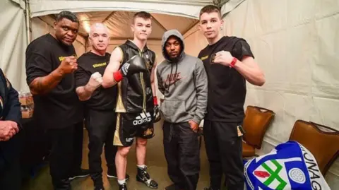 Team McKenna Kendrick Lamar poses with Aaron and Stephen McKenna and members of their team backstage before one of Aaron's early professional fights in California.