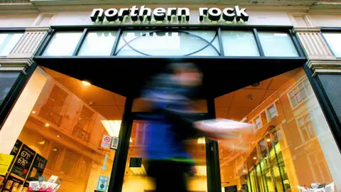 Man walks past a Northern Rock branch