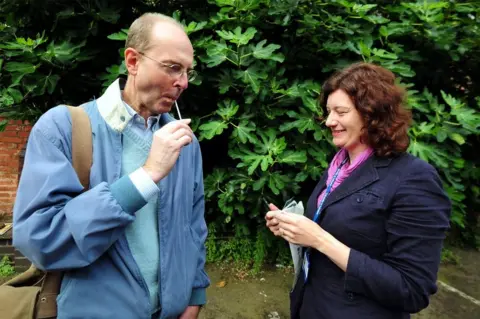 PA Dr Turi King from Leicester University gives Michael Ibsen, a 17th generation great nephew of Richard III, a DNA swab at Greyfriars car park in Leicester during an archaeological search for the lost grave of Richard III, 24 August 2012